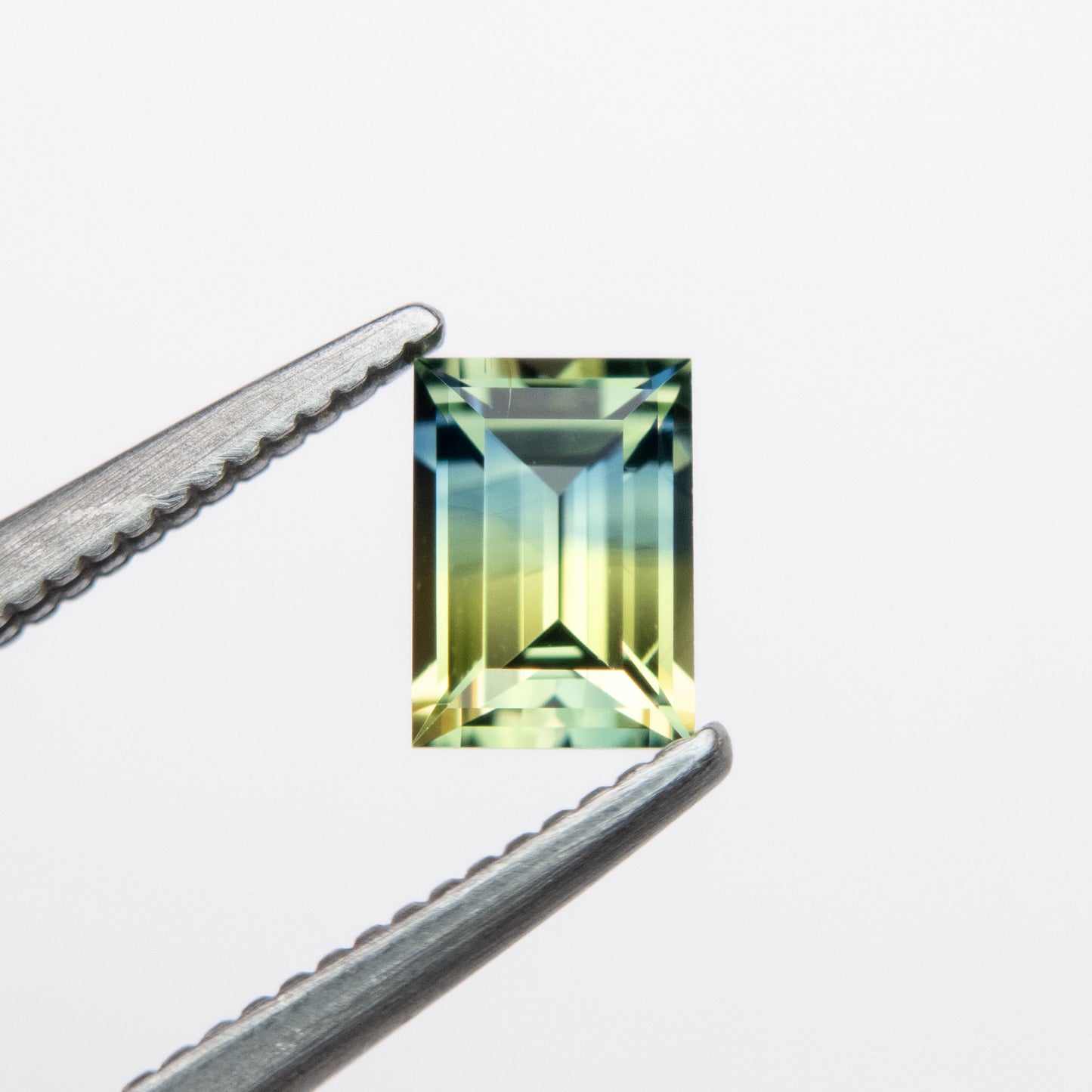 0.59ct 5.54x3.95x2.65mm Parti Blue-Green Step Cut Baguette Sapphire EGEM-62