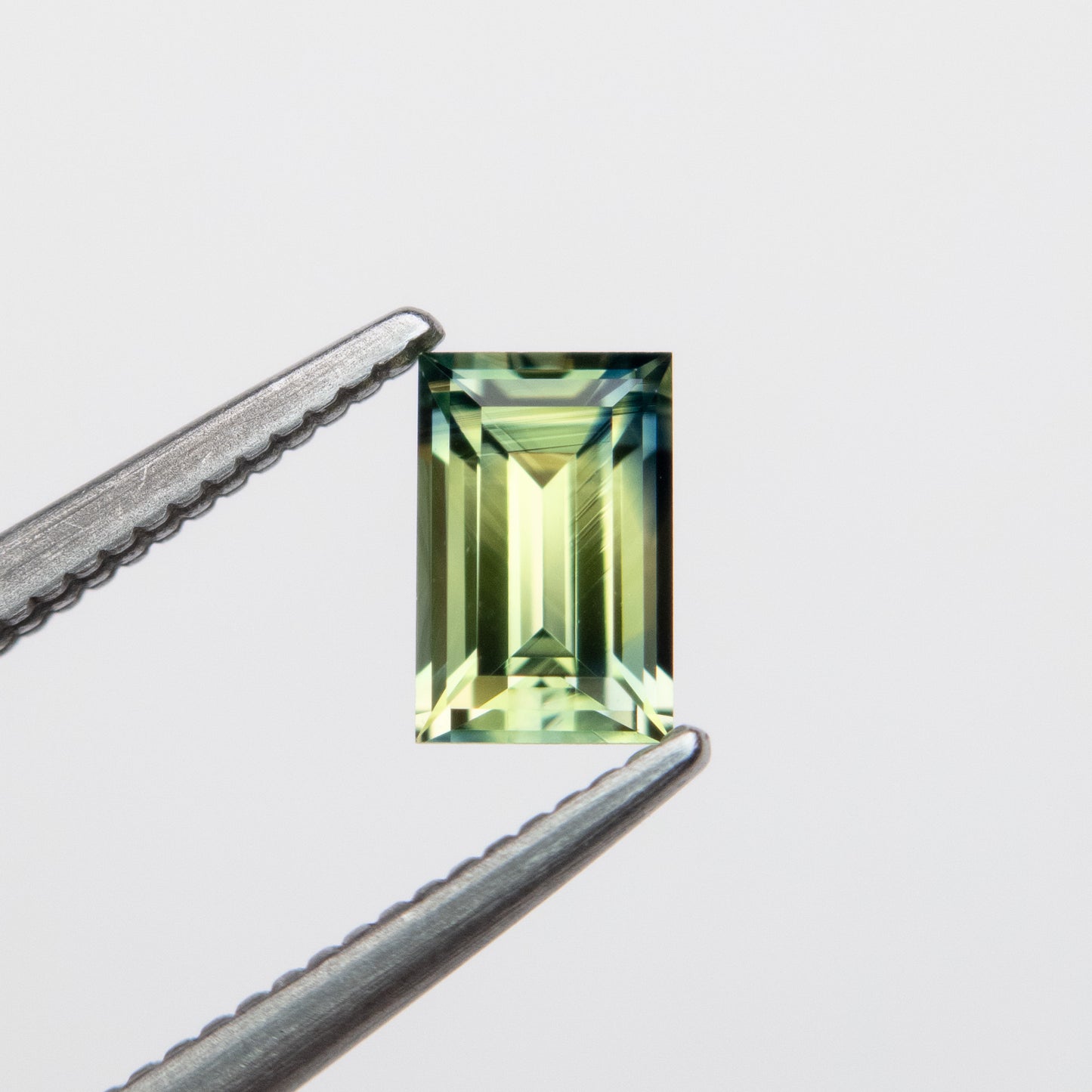 0.59ct 5.79x3.76x2.62mm Parti Blue-Green Step Cut Baguette Sapphire EGEM-63