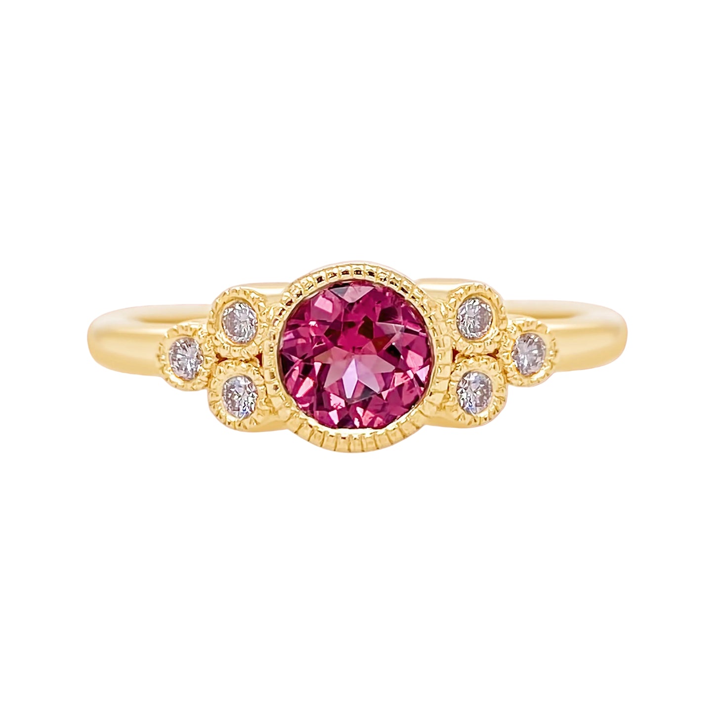 Gold ring with a pink gemstone and smaller diamonds on a white background
