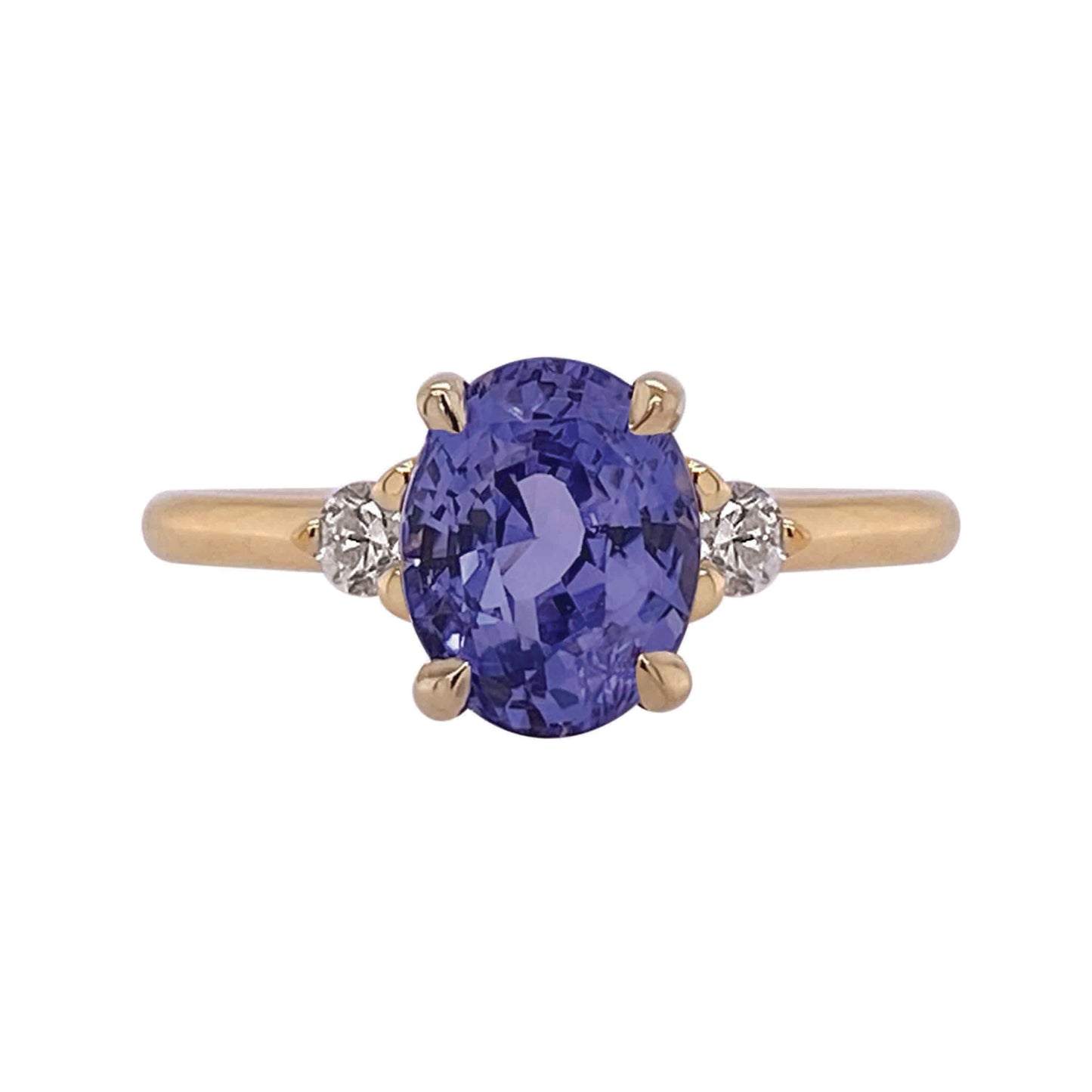 Design: A timeless three setting featuring a juicy sapphire the colour of one of my favourite abundant perennial flowers, wild indigo! This super low profile ring is accented with Canadian diamonds and set in yellow gold that makes the violet gem colour pop on the hand. Stack her with the Dawn contour band to complete the look shown. 2.21c oval sapphire 0.11c total weight F VS diamonds Slim 1.75mm round profile band 6mm rise off finger (based on depth of stone) Size 6.25 (complimentary sizing available)