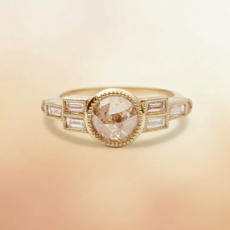 Gold ring with a central diamond and baguette-cut stones on a white background