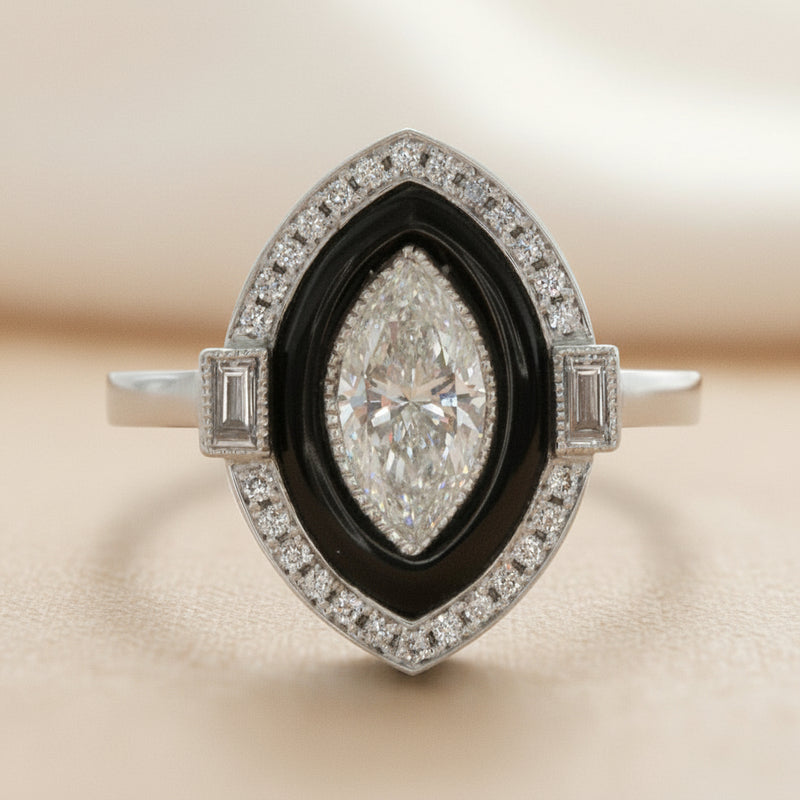 Diamond ring with black center and diamond accents on a white background