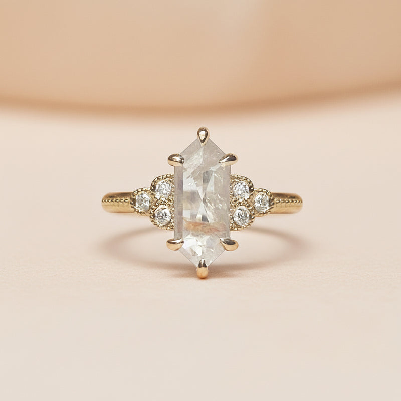 Diamond ring with a hexagonal center stone on a white background