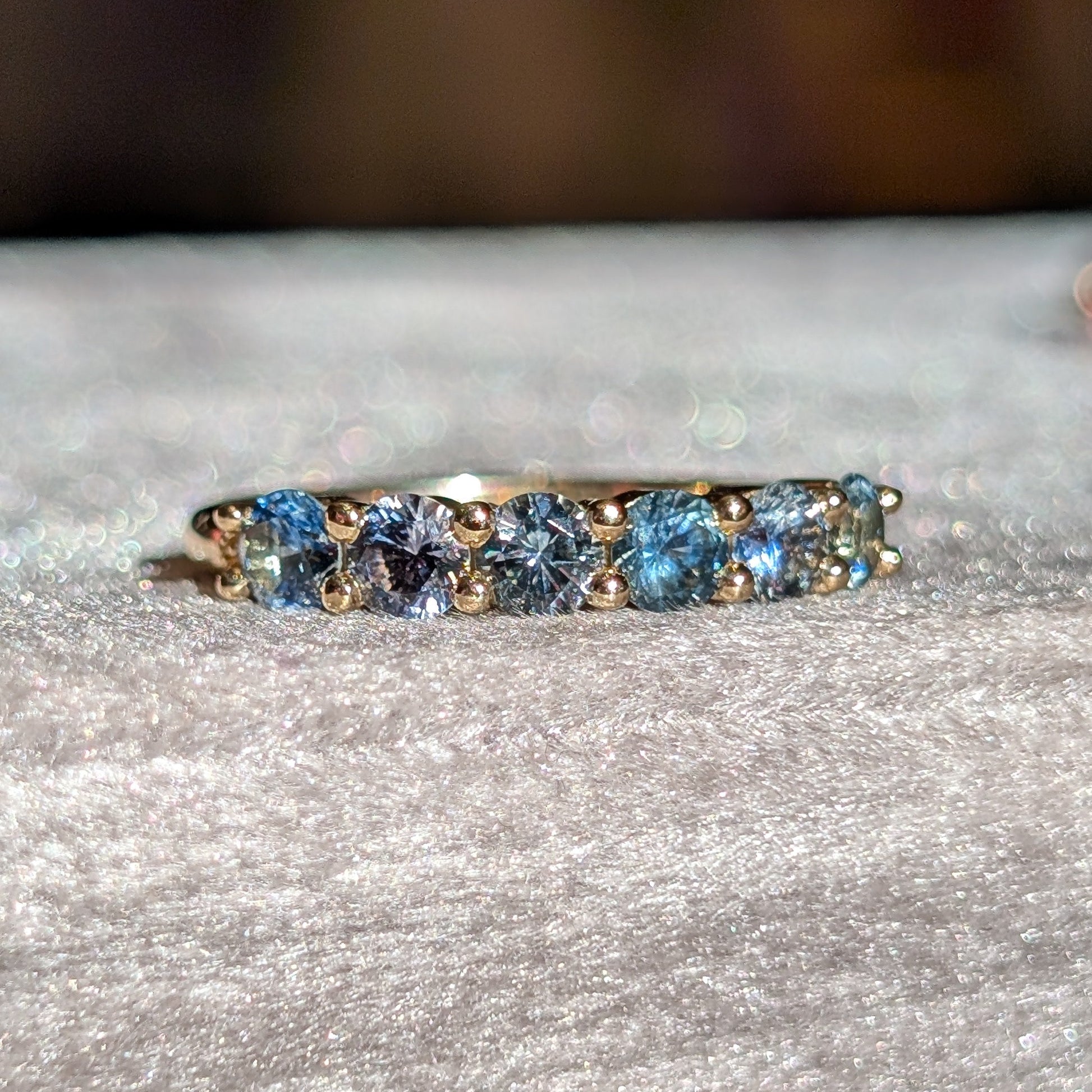 Ring with blue gemstones on a textured surface