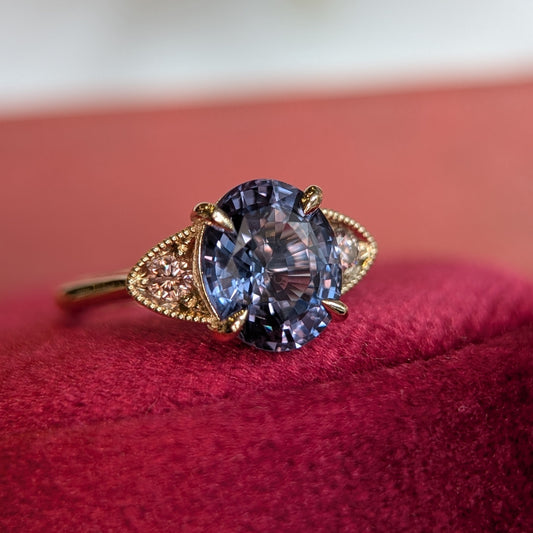 Ring with a blue gemstone on a red surface