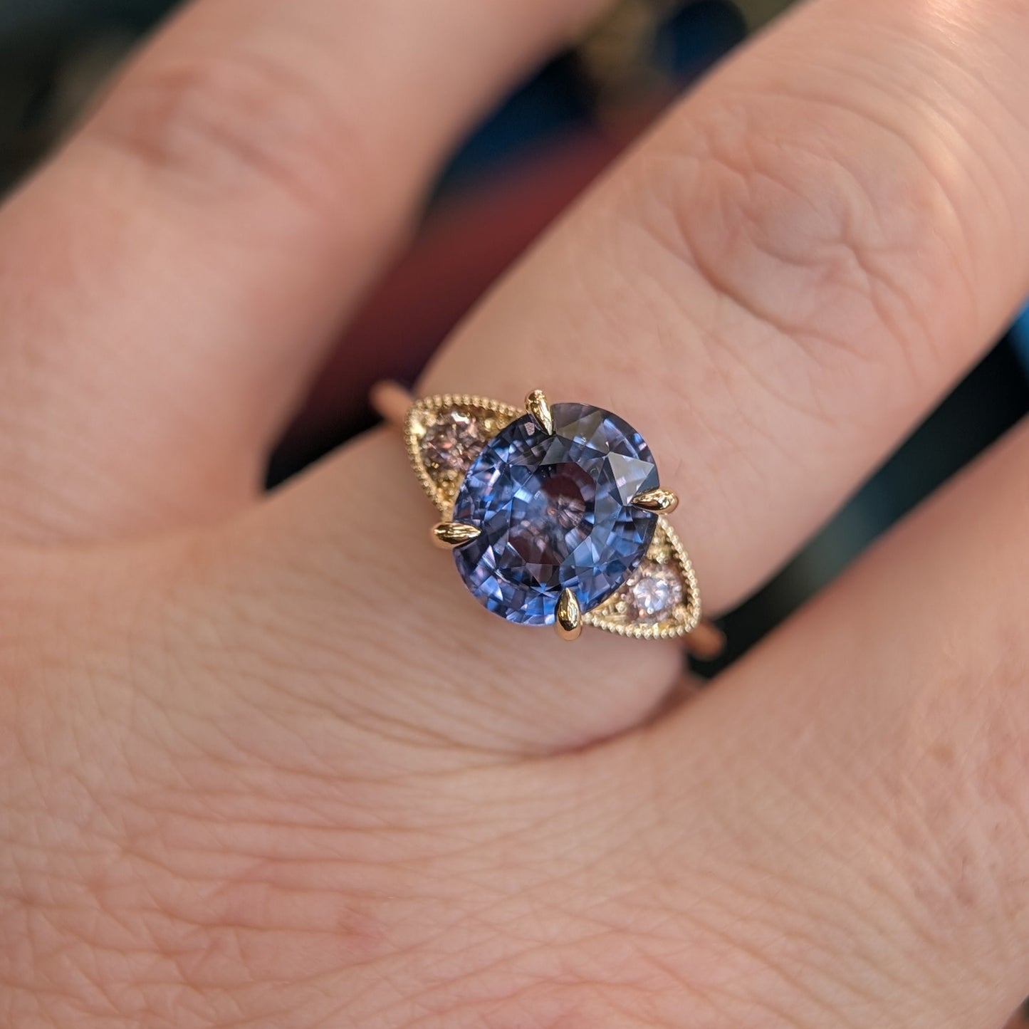 Ring with purple gemstone on a finger