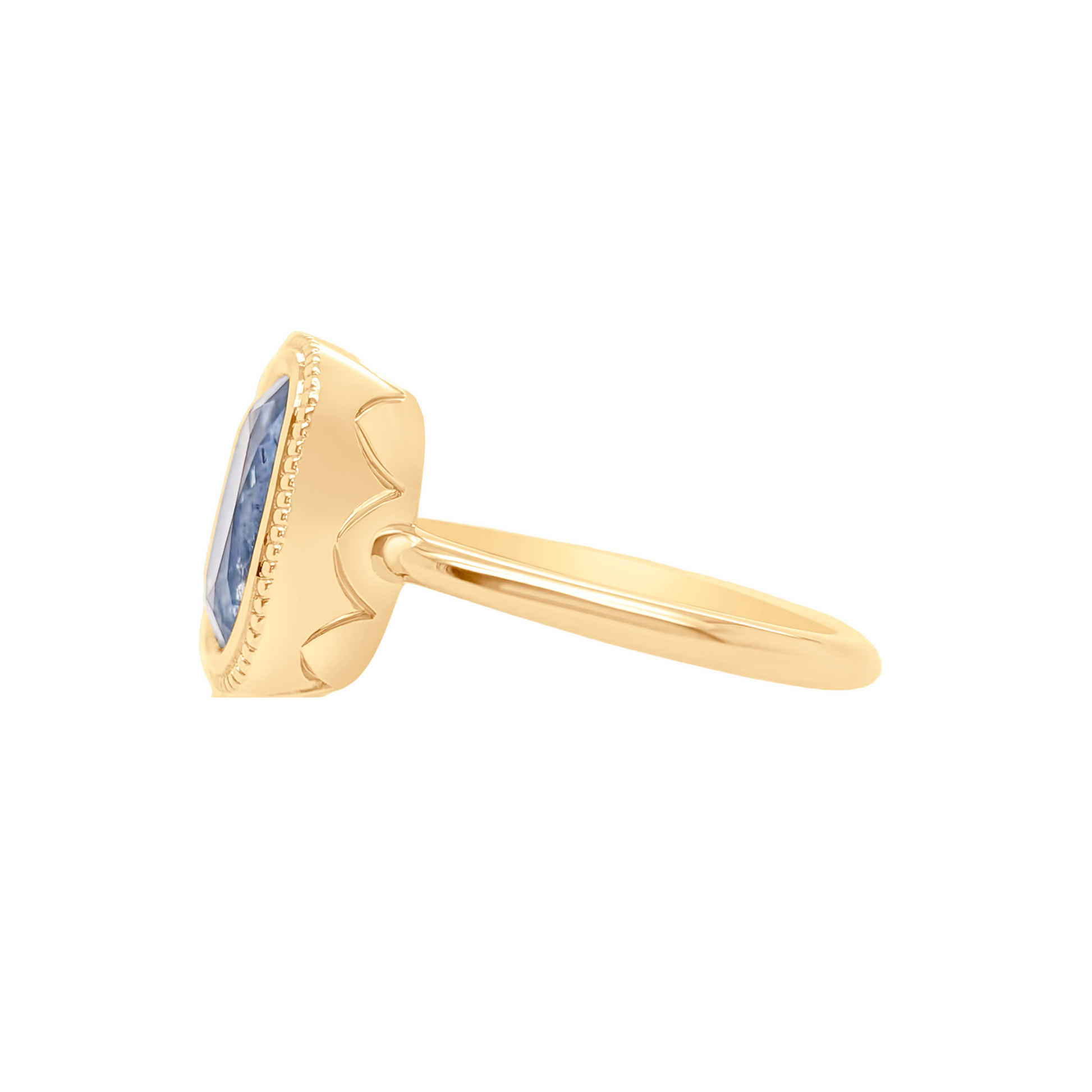 Gold ring with a blue gemstone on a white background
