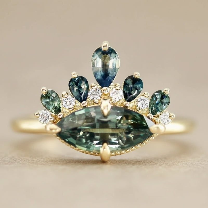 Gold ring with green gemstones on a light gray background