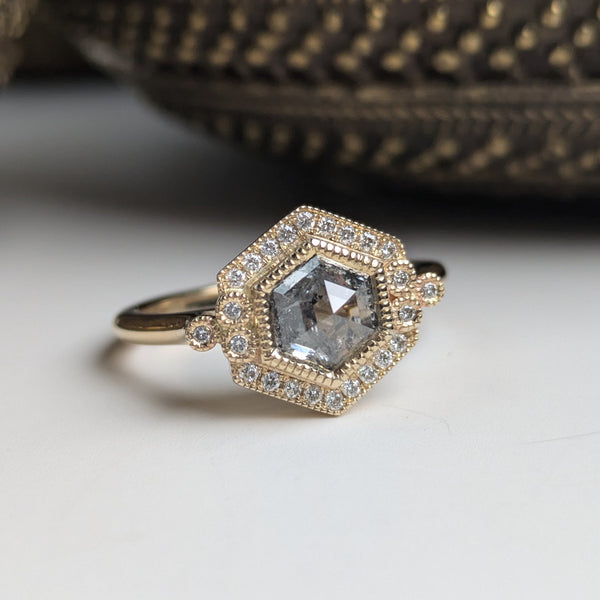 Gold ring with a diamond on a white background