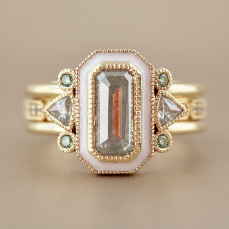 Gold ring with gemstones on a light background