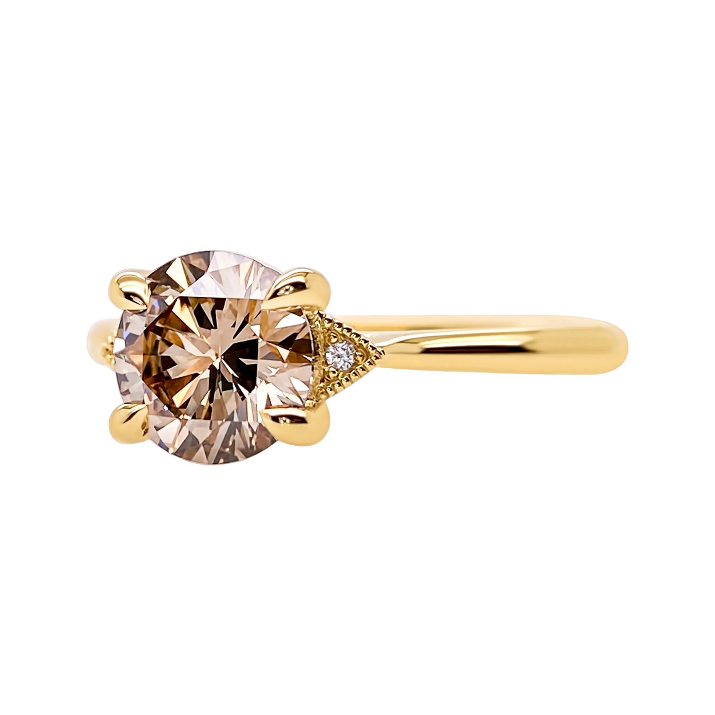 Gold ring with a large diamond and smaller gemstones on a white background