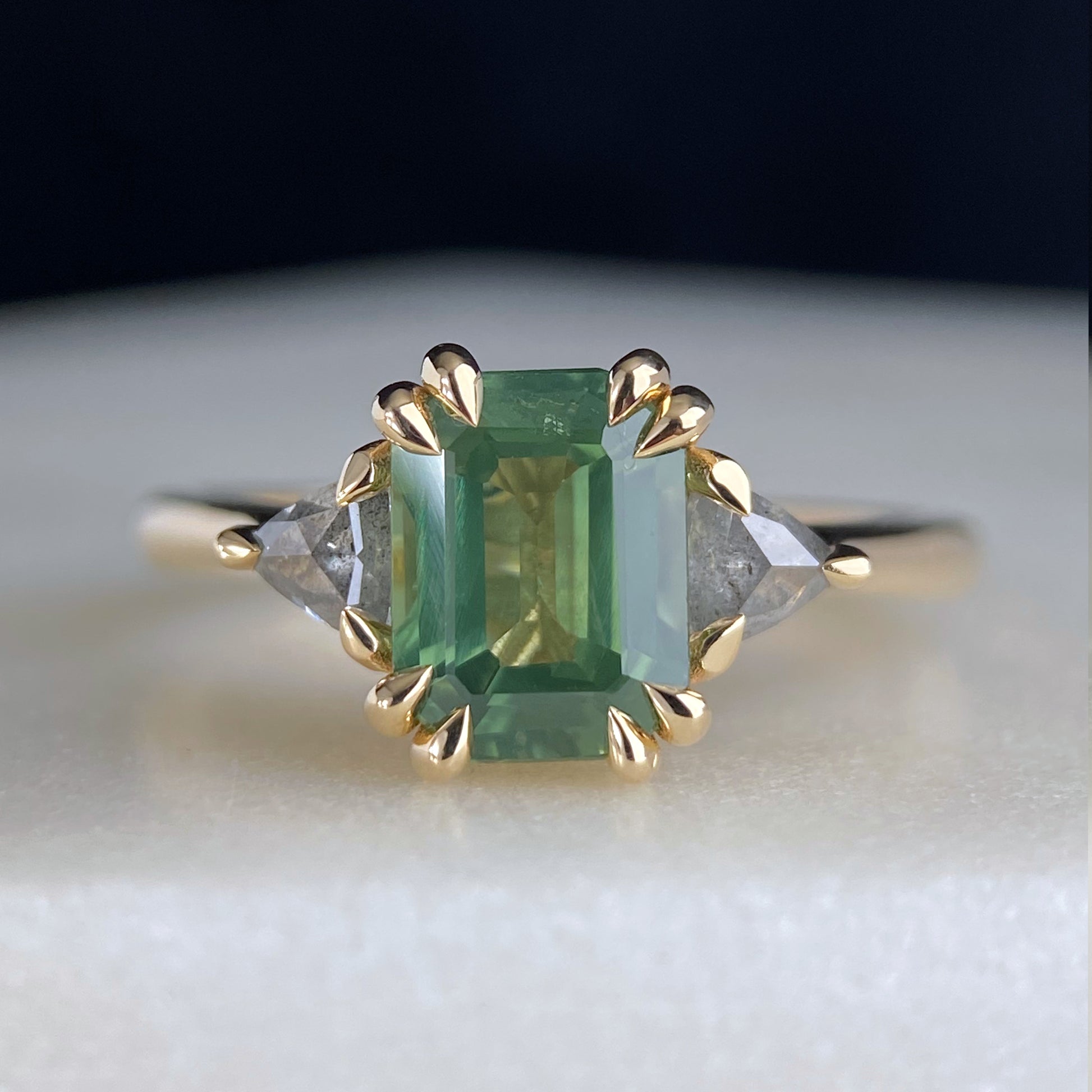 Emerald Cut Australian Green Sapphire with Salt and Pepper Trillion Diamond Accents Double Claw Engagement Ring 14K yellow gold