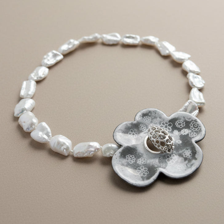 pearl necklace with a floral pendant