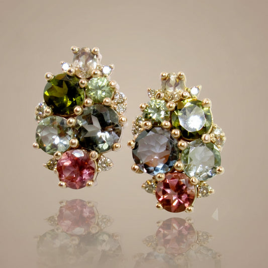 A pair of rose gold earrings with a cluster of multicolored tourmaline and sapphire gems.