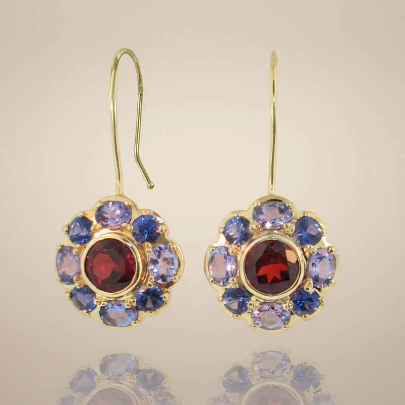 A pair of gold-colored bouquet earrings featuring a floral pattern with blue, red, and purple gemstones.