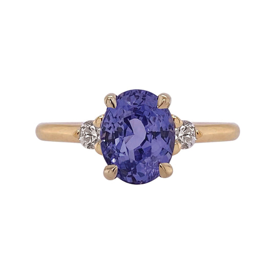 Design: A timeless three setting featuring a juicy sapphire the colour of one of my favourite abundant perennial flowers, wild indigo! This super low profile ring is accented with Canadian diamonds and set in yellow gold that makes the violet gem colour pop on the hand. Stack her with the Dawn contour band to complete the look shown. 2.21c oval sapphire 0.11c total weight F VS diamonds Slim 1.75mm round profile band 6mm rise off finger (based on depth of stone) Size 6.25 (complimentary sizing available) 