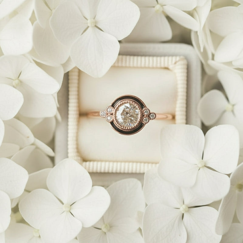 Gold ring with a diamond in a box surrounded by purple flowers